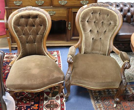 A pair of Victorian ladies and gents button back walnut armchairs